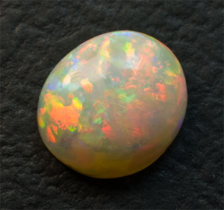 Very Colorful Milky Opal 1.6 carats domed red, yellow, green, and indigo blue 2990